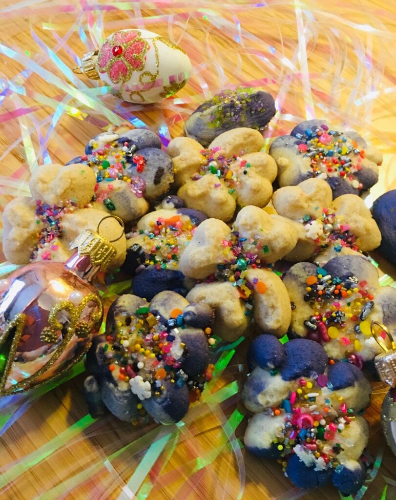 A pile of cookies with colorful sprinkles on them.