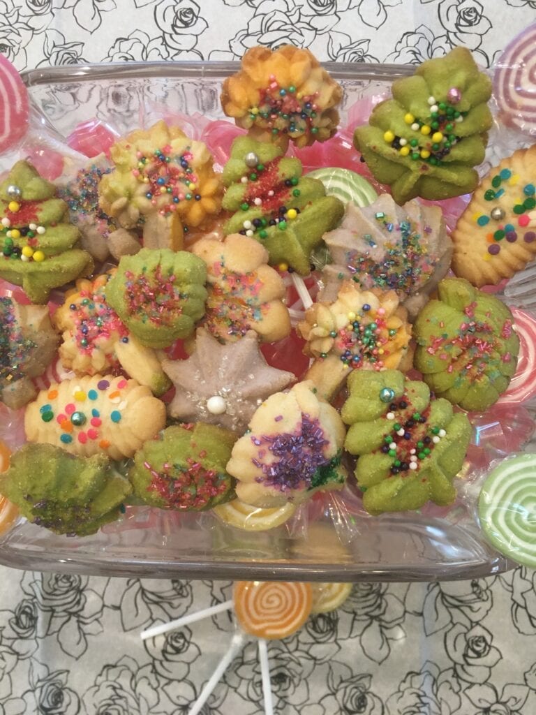 A tray of cookies with different colored sprinkles.