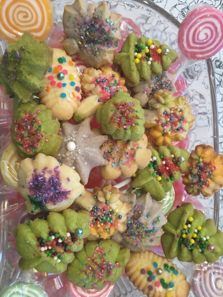 A tray of cookies with different colors and designs.