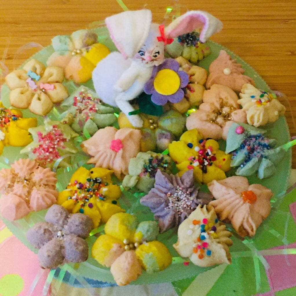 A cake covered in colorful candies and flowers.