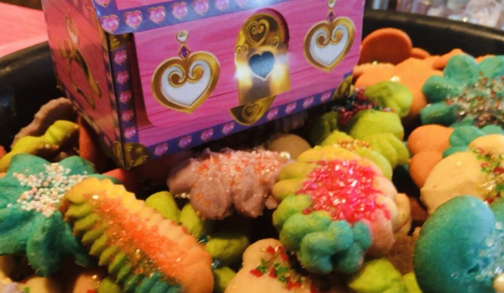 A box of cookies with different colored icing.