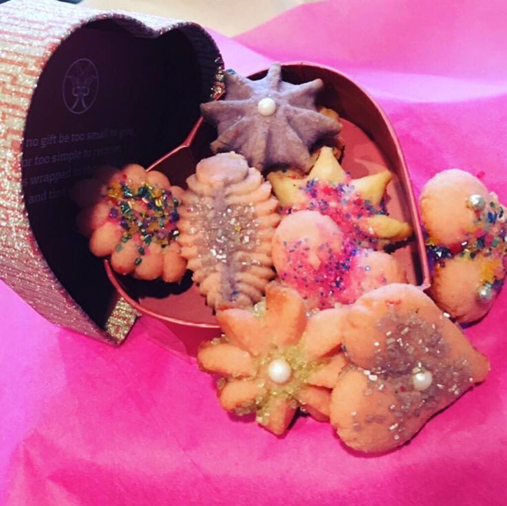 A basket of cookies on top of a pink table.