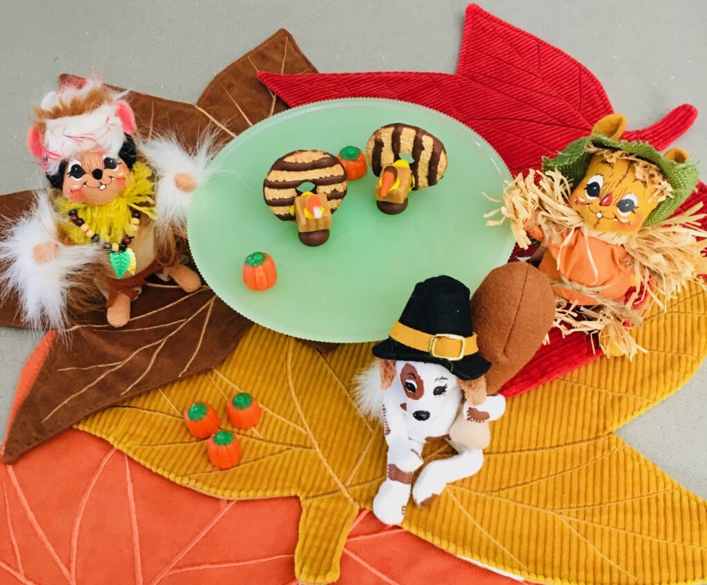 A table with leaves and figurines of animals.