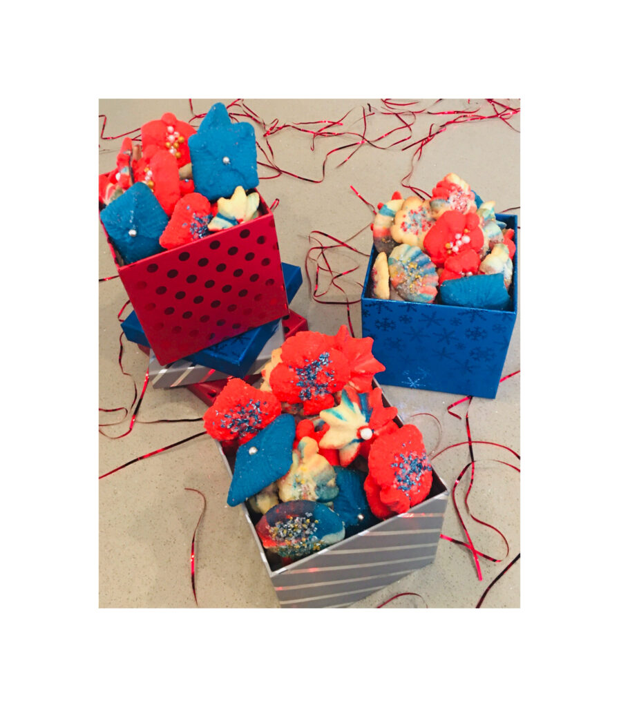 A group of three baskets filled with cookies.