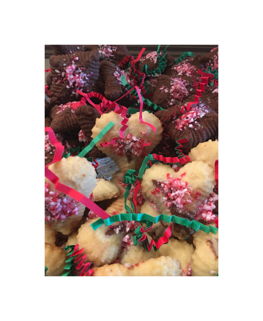 A pile of cookies with pink and green ribbons.