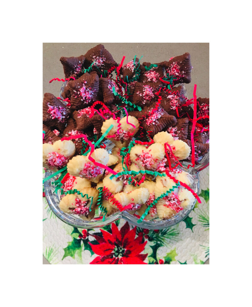 A bowl of cookies and brownies on top of a table.