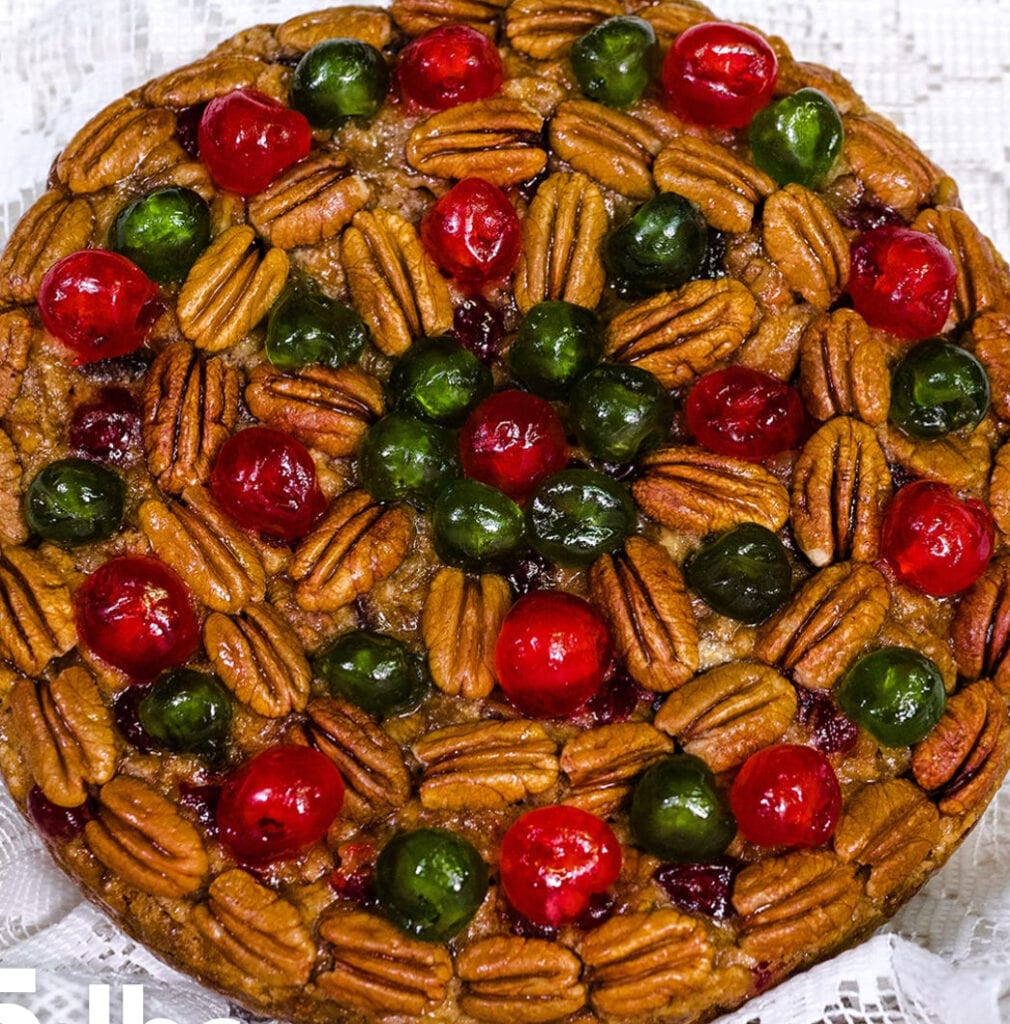 A pie with different colored nuts on top of it.