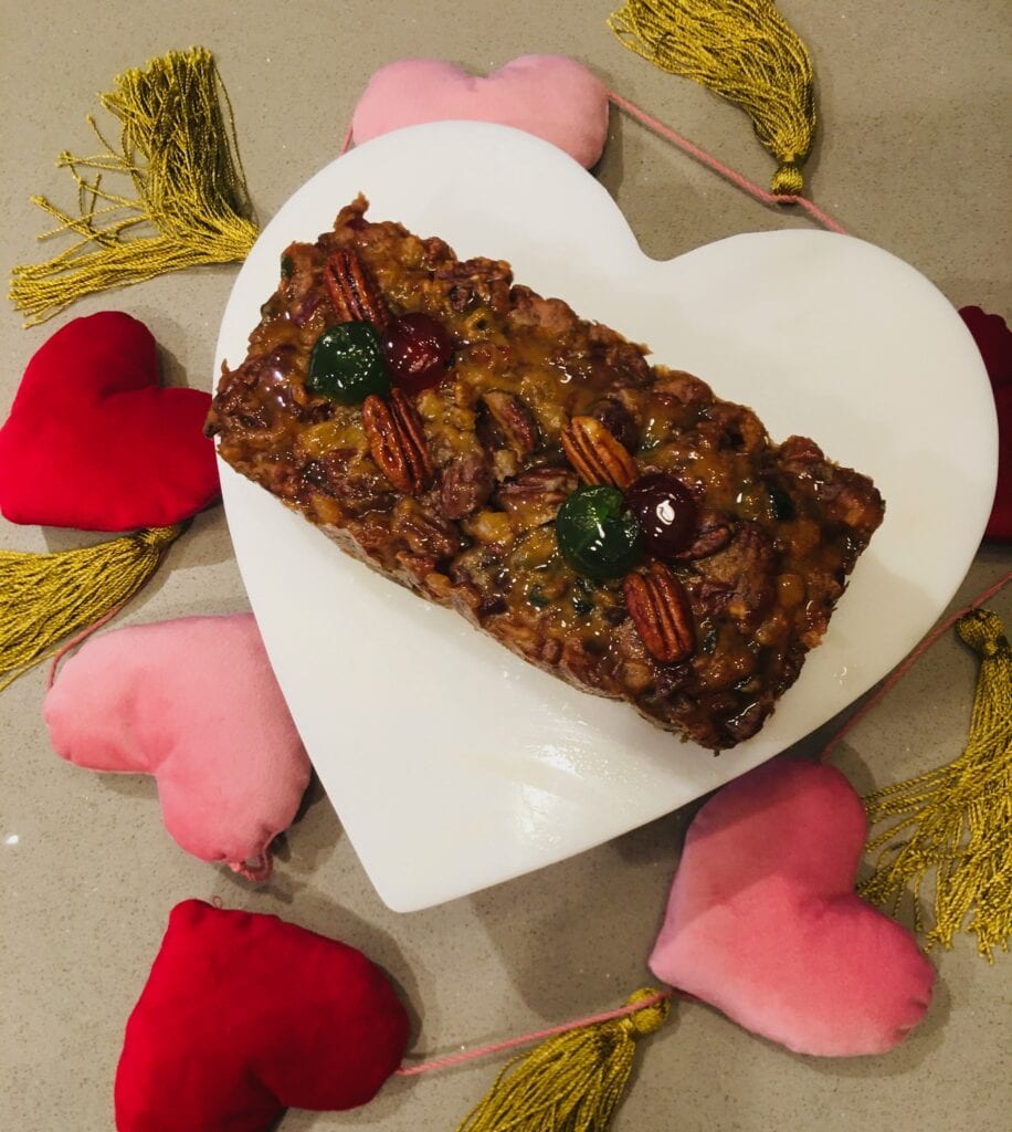 A white heart shaped plate with some food on it